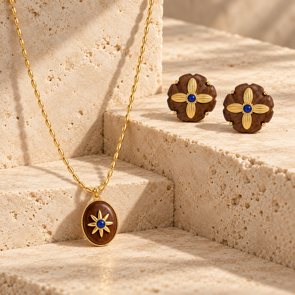 Motu Blue collection image featuring a pendant necklace and matching floral stud earrings on warm stone steps