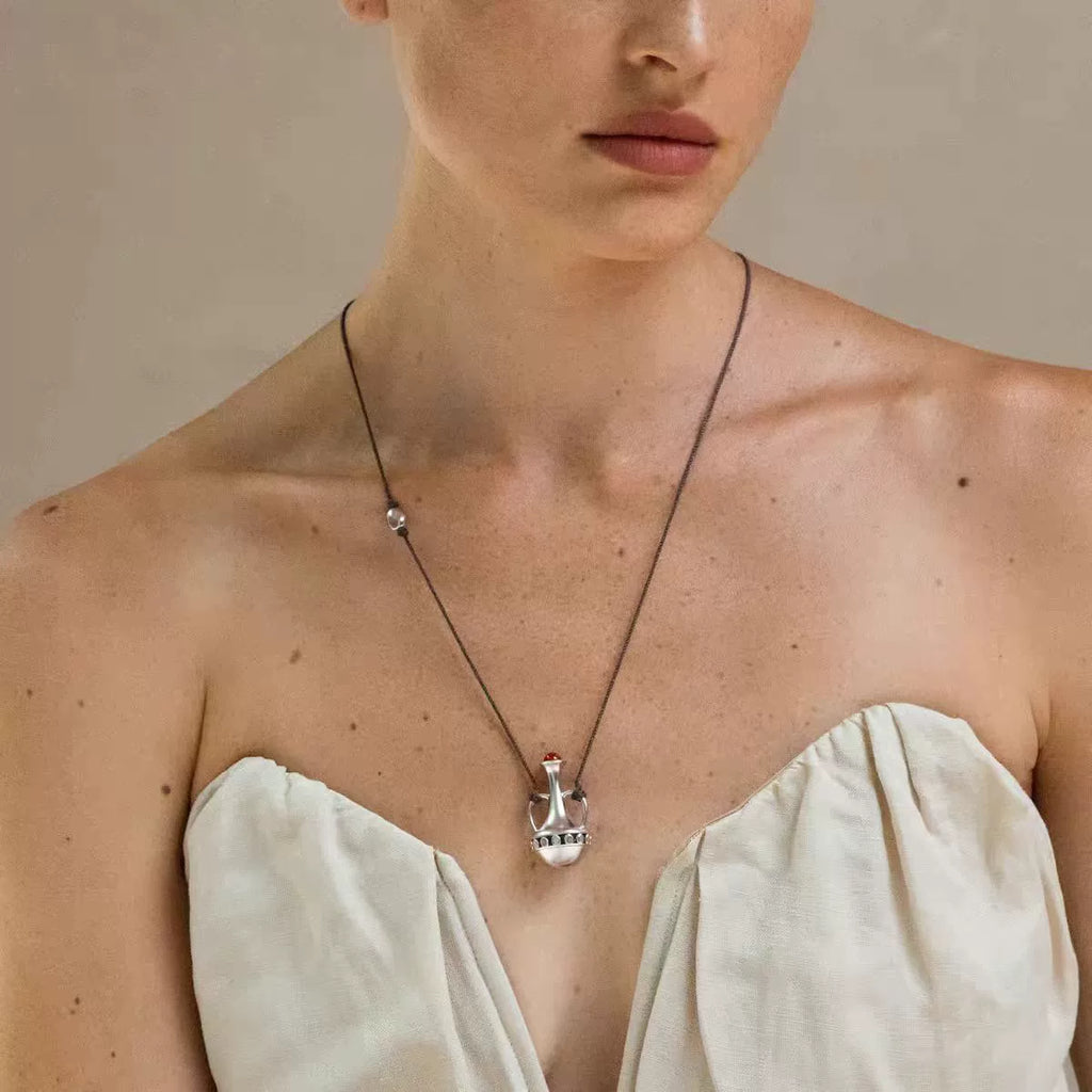 Silver-tone amphora red agate cord necklace styled on model