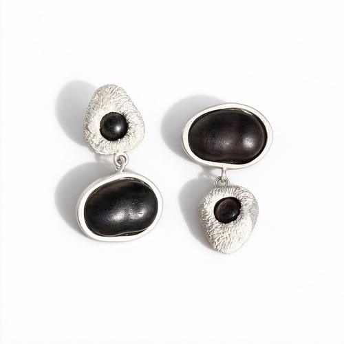Black asymmetric wood stud earrings with silver-tone details