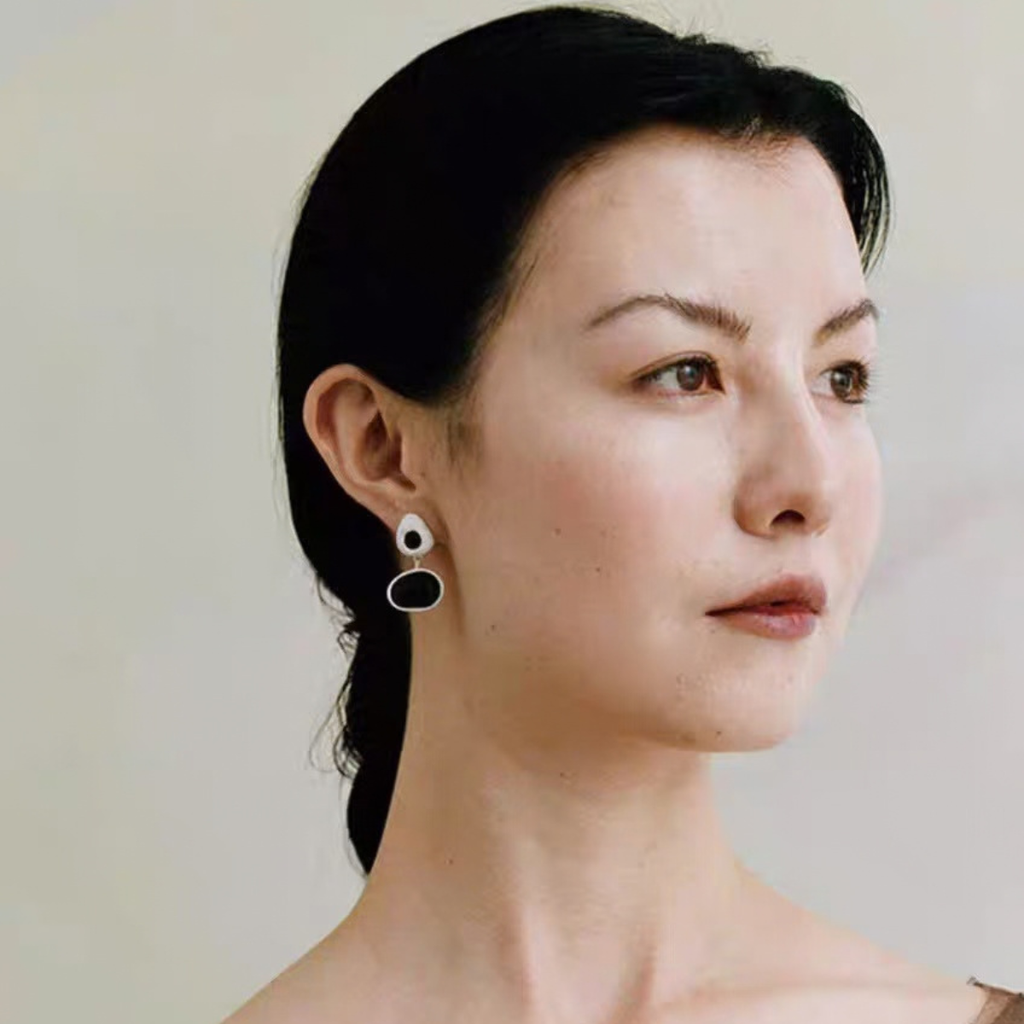 Model wearing Black asymmetric wood stud earrings