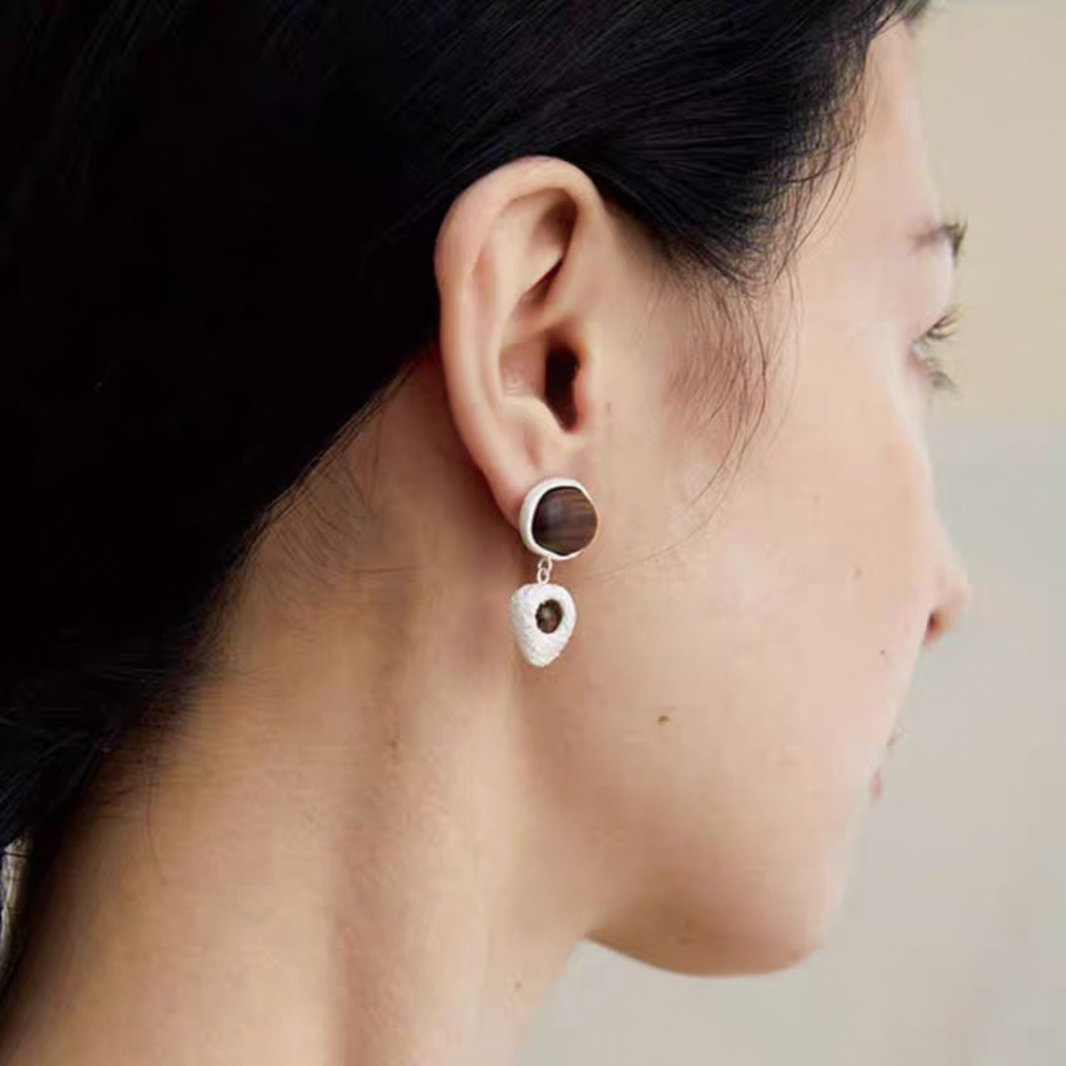 Model wearing Dark Brown asymmetric wood stud earrings