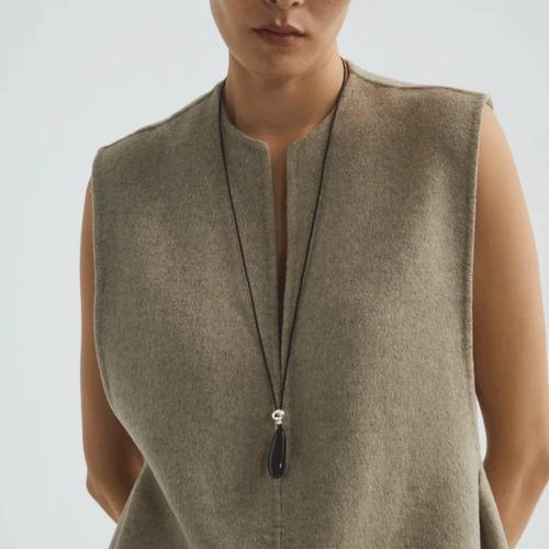 Black onyx pendant necklace styled as a long statement piece