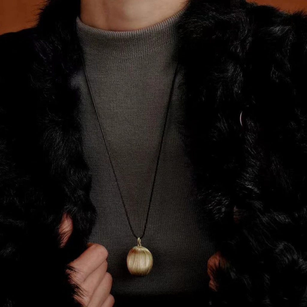 Model wearing Bound Light brushed pendant necklace in Gold-Tone