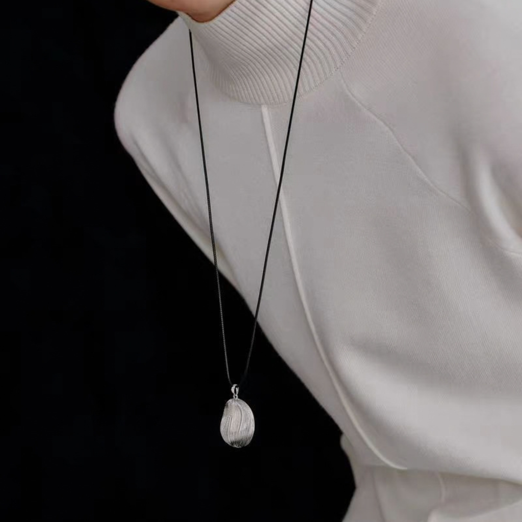 Model wearing Bound Light brushed pendant necklace in Silver-Tone