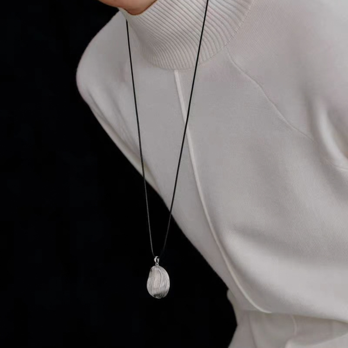 Model wearing Bound Light brushed pendant necklace in Silver-Tone
