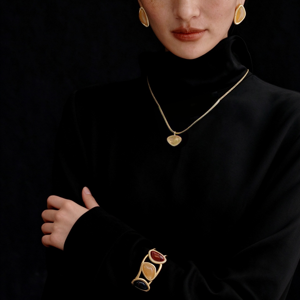 Model wearing the Gold-Tone Bound Light short necklace, earrings and cuff three-piece set