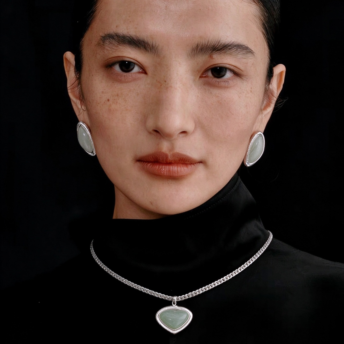 Model wearing the Silver-Tone Bound Light short natural stone necklace and triangle earrings