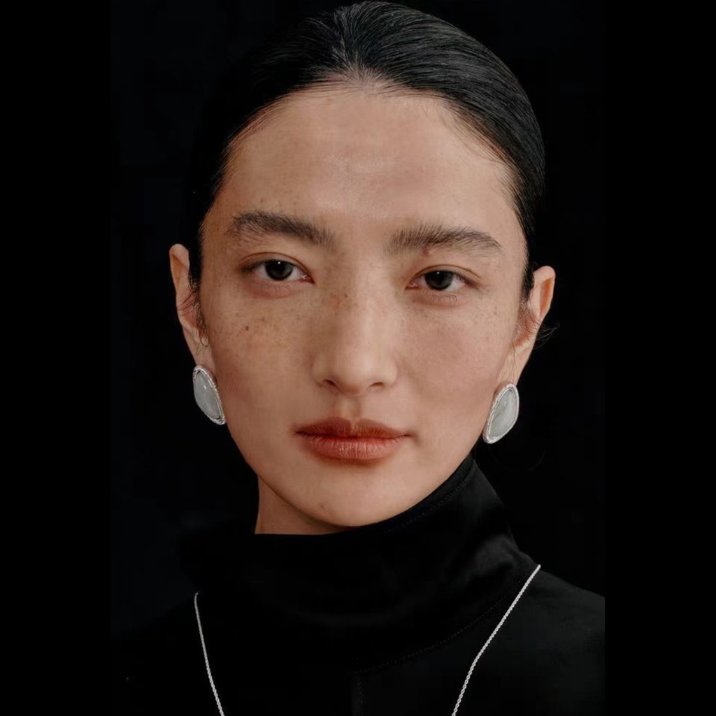 Model wearing the Bound Light natural stone triangle stud earrings in Silver-Tone finish