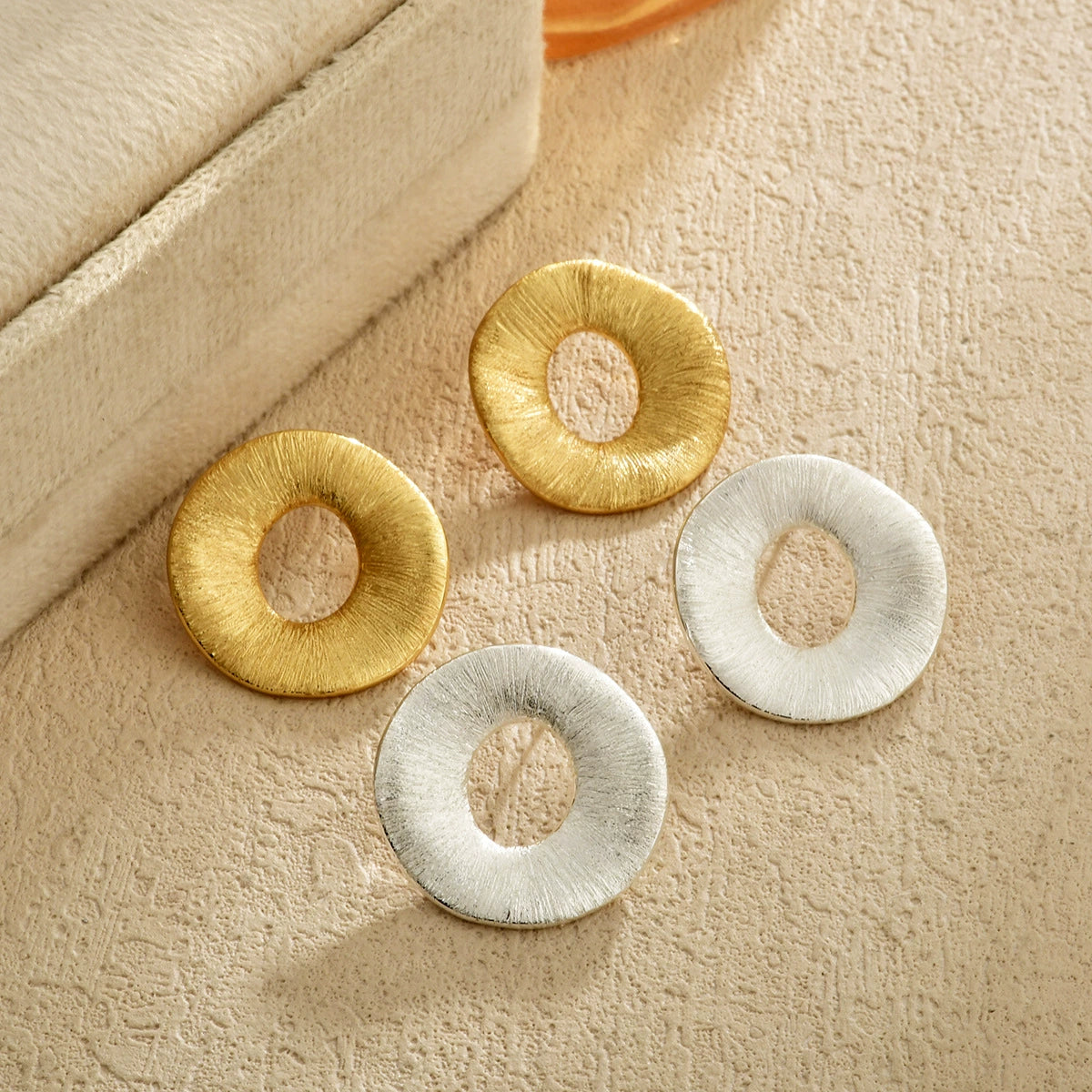 Brushed halo stud earrings in gold-tone and silver-tone finishes
