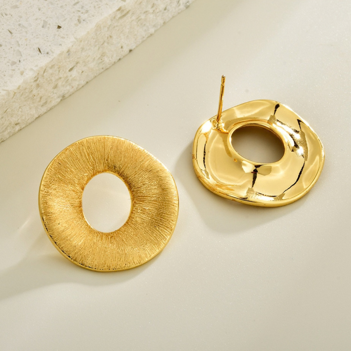 Back and texture detail of gold-tone brushed halo stud earrings
