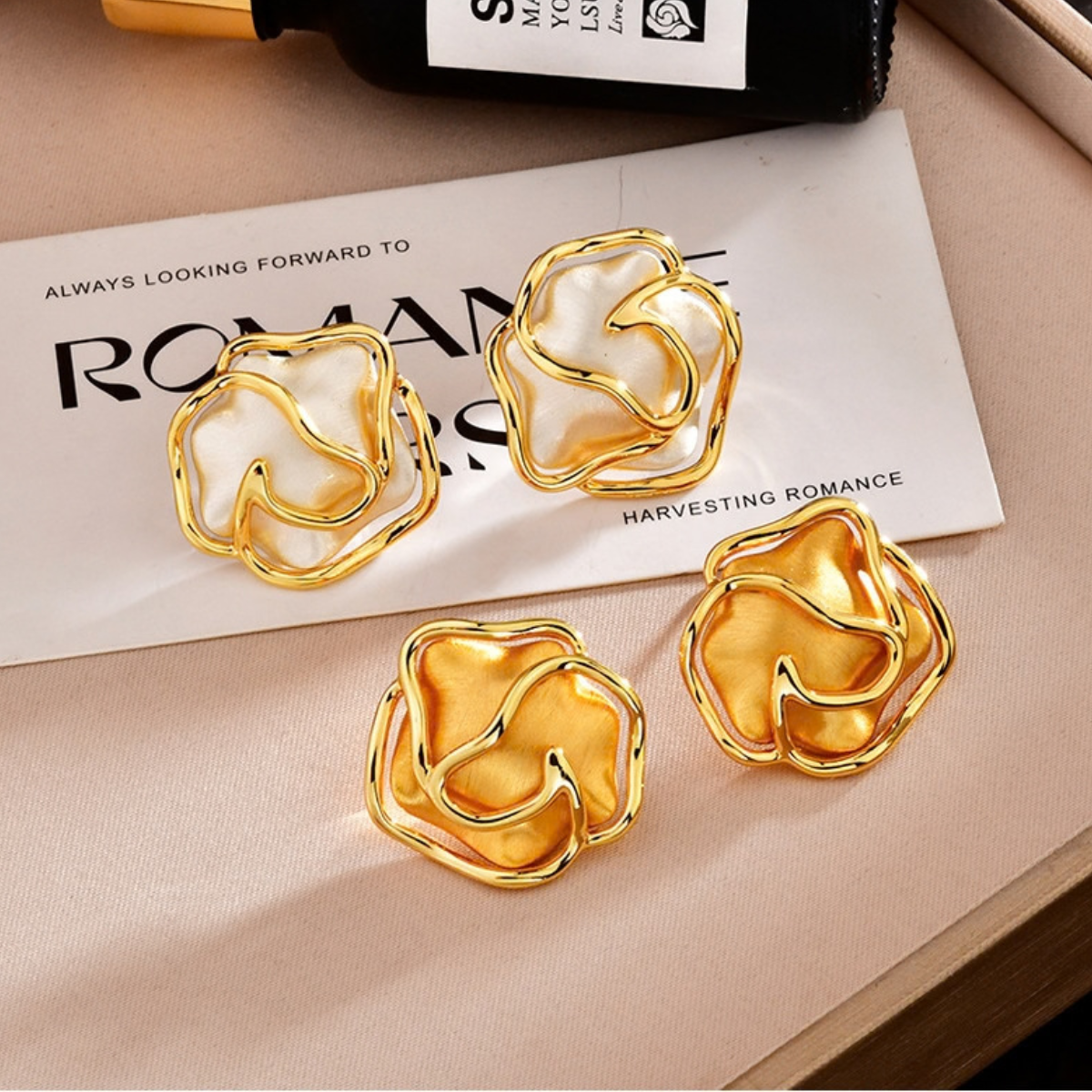 Brushed open rose stud earrings shown in gold-tone and silver-tone finishes