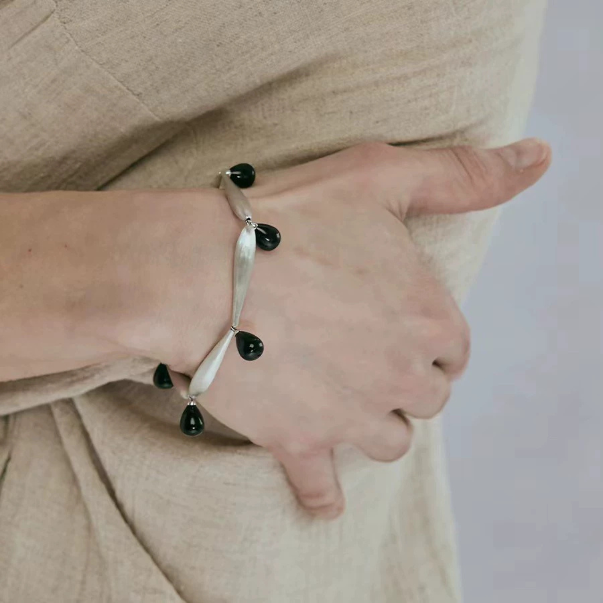 Close-up of Brushed Silver Black Onyx bracelet worn on wrist