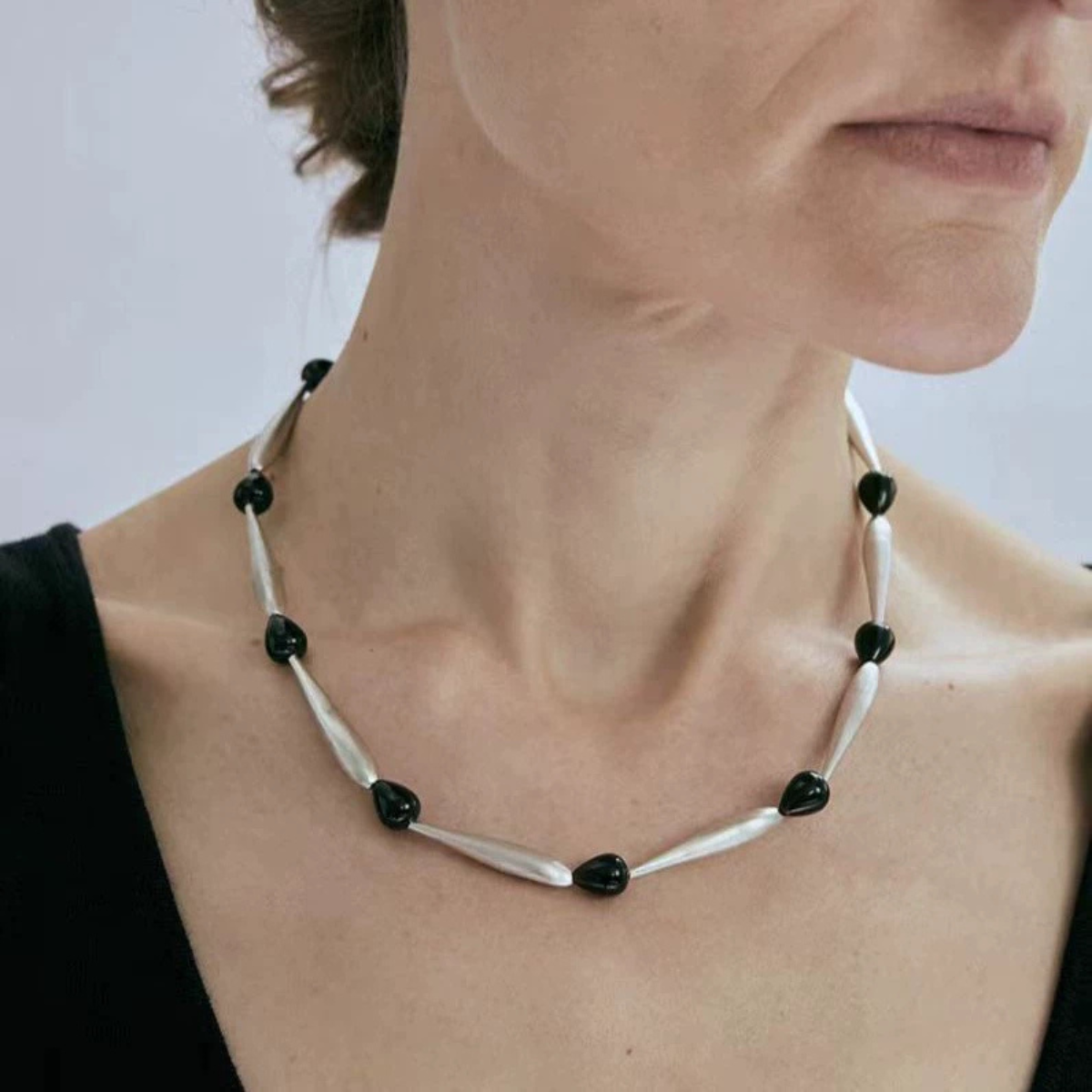 Model wearing Brushed Silver Black Onyx sculptural necklace