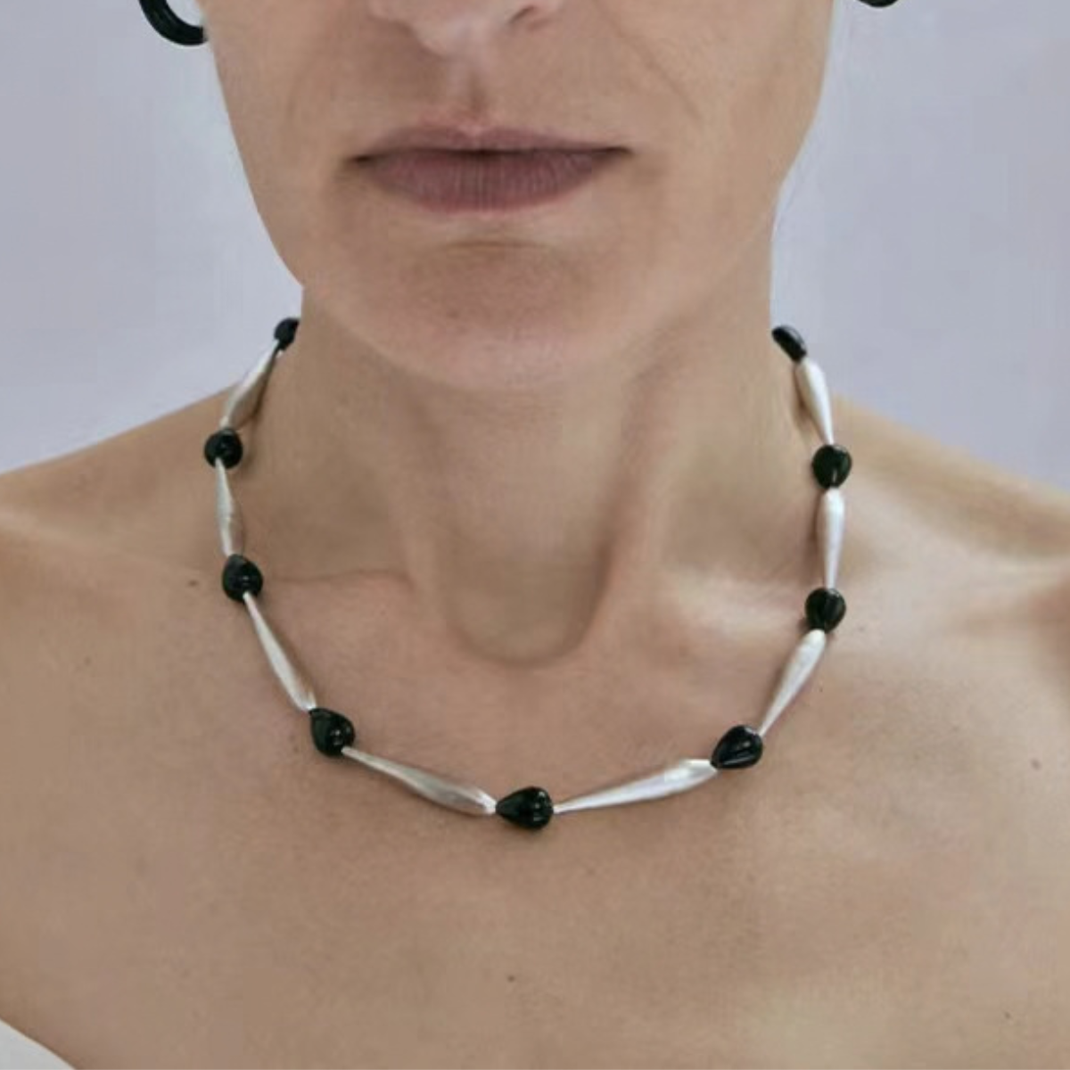 Model wearing Brushed Silver Black Onyx sculptural necklace details