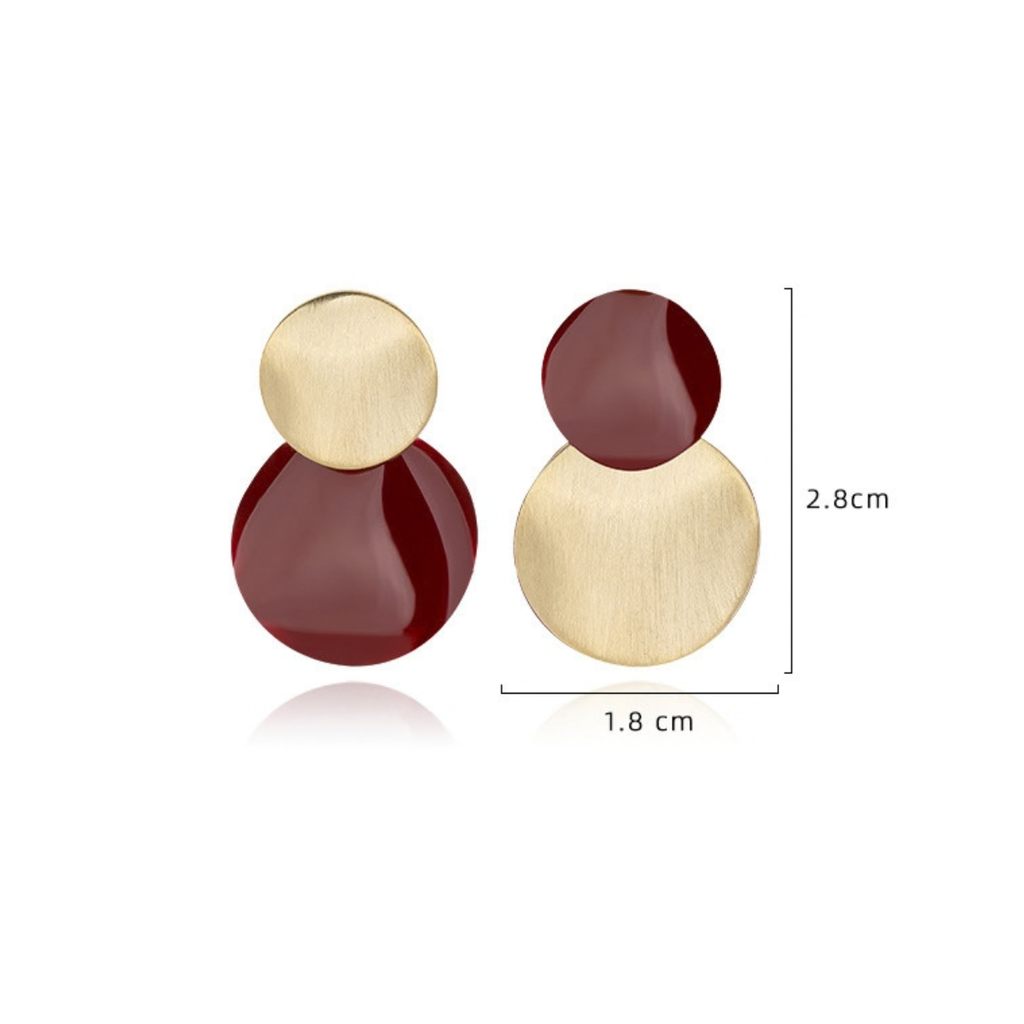 Burgundy sculptural stud earrings in gold and red, approximately 28 × 18 mm