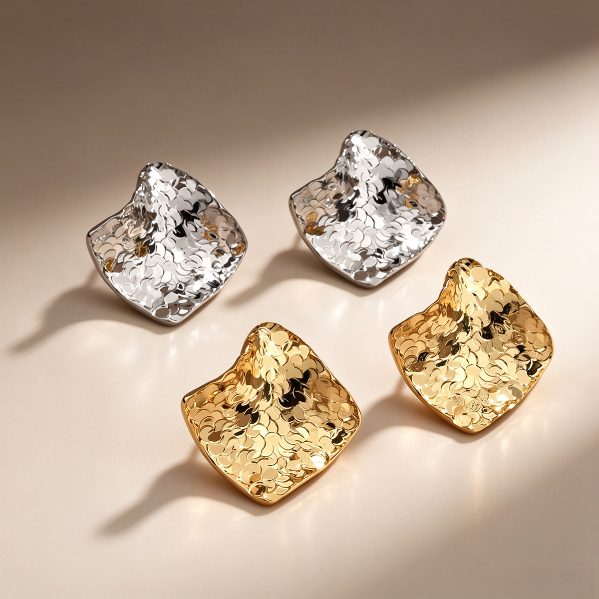 Crinkled sculptural stud earrings in a square shape, available in gold-tone and silver-tone finishes