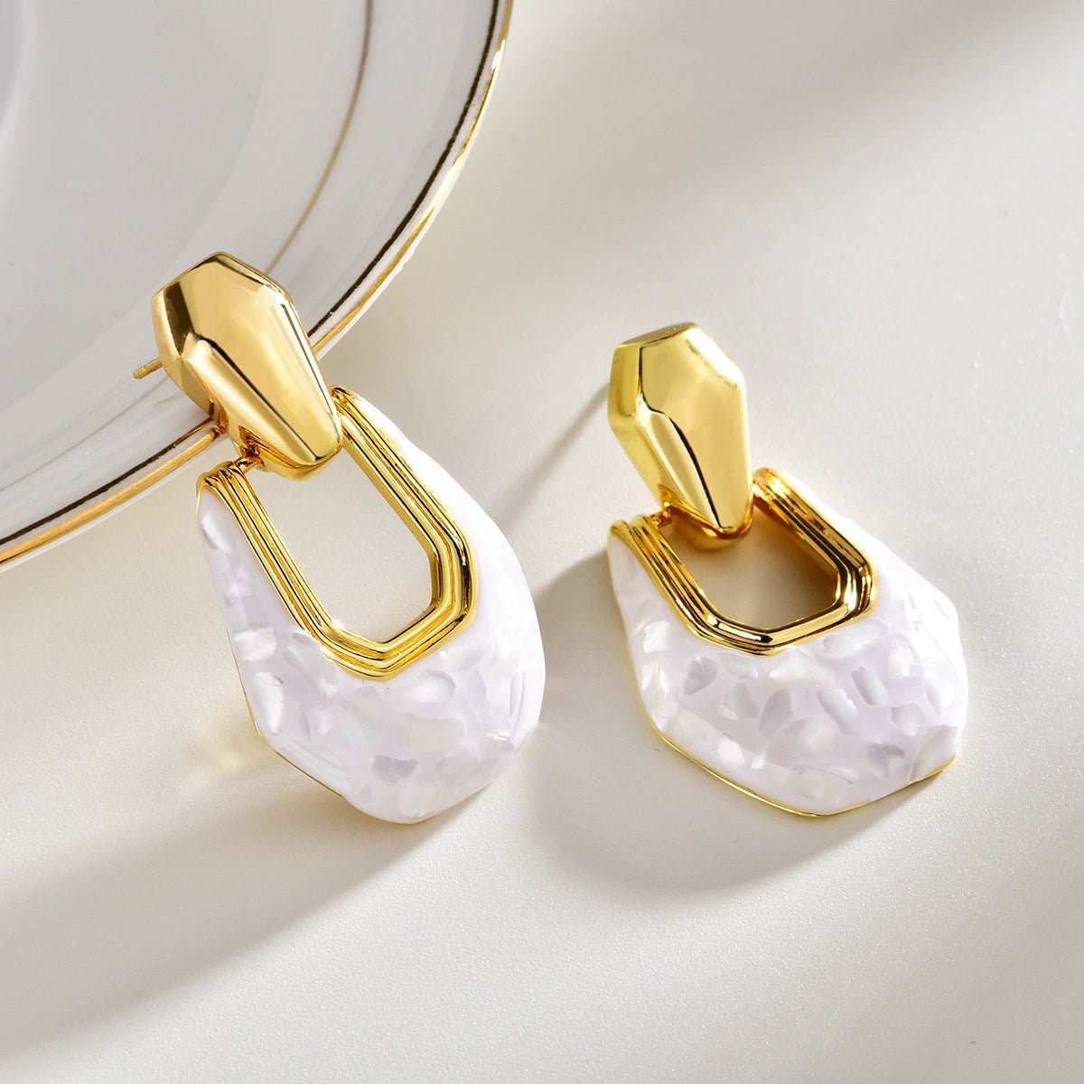 White shell geometric drop earrings with gold-tone open-frame details