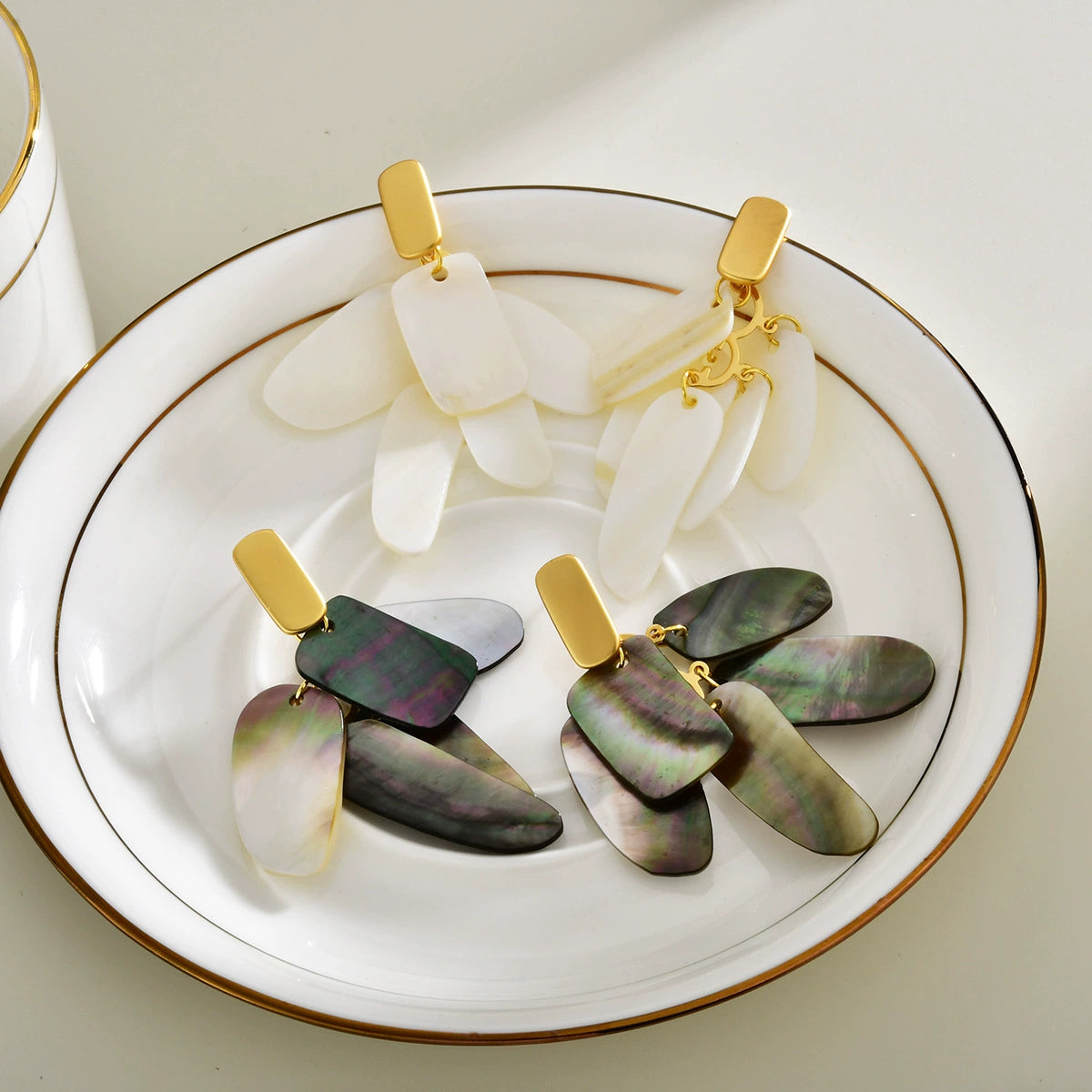 Abalone shell and white shell layered drop earrings with gold-tone tops