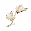 Gold-tone magnolia pearl branch brooch with zircon accents