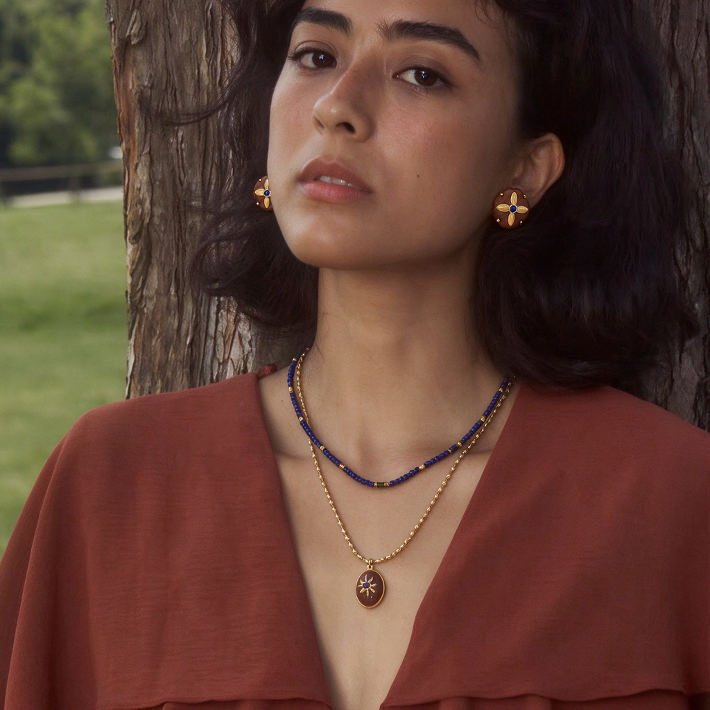 Model wearing the complete Motu Blue layered necklace and stud earring jewelry set