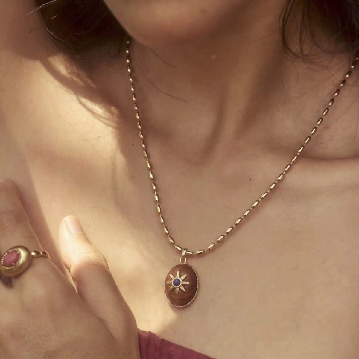 Model wearing the Motu Blue wood and lapis pendant necklace