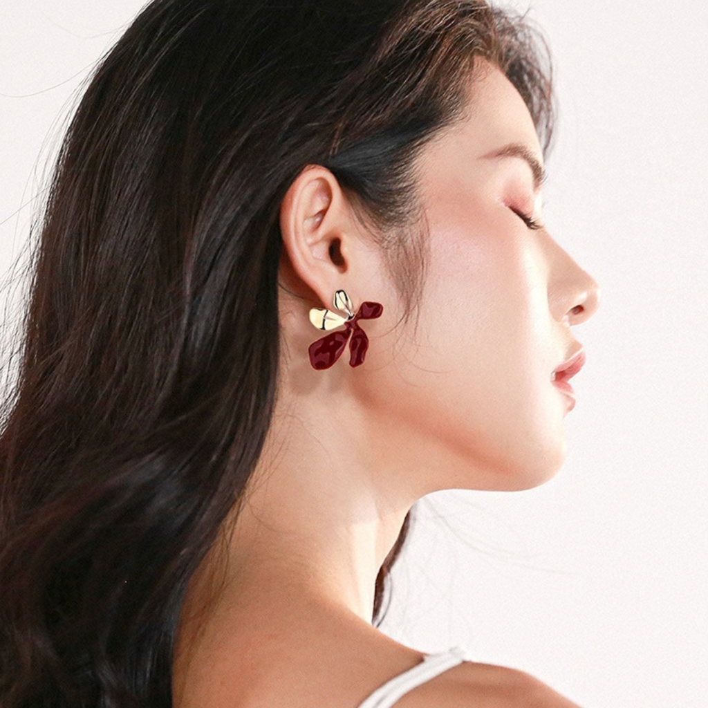 Model wearing Petal Form Stud Earrings in red