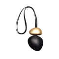 Sculptural Dark Wood Cord Necklace with gold-tone brass pendant