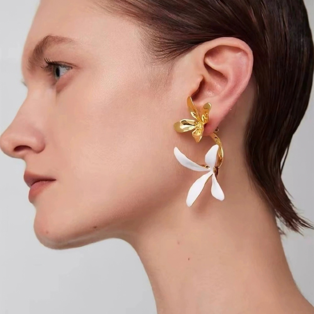 Model wearing Sculptural Orchid earrings in white enamel and Gold-Tone