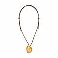 Gold-tone sculptural pebble pendant necklace with an adjustable dark cord on a white background