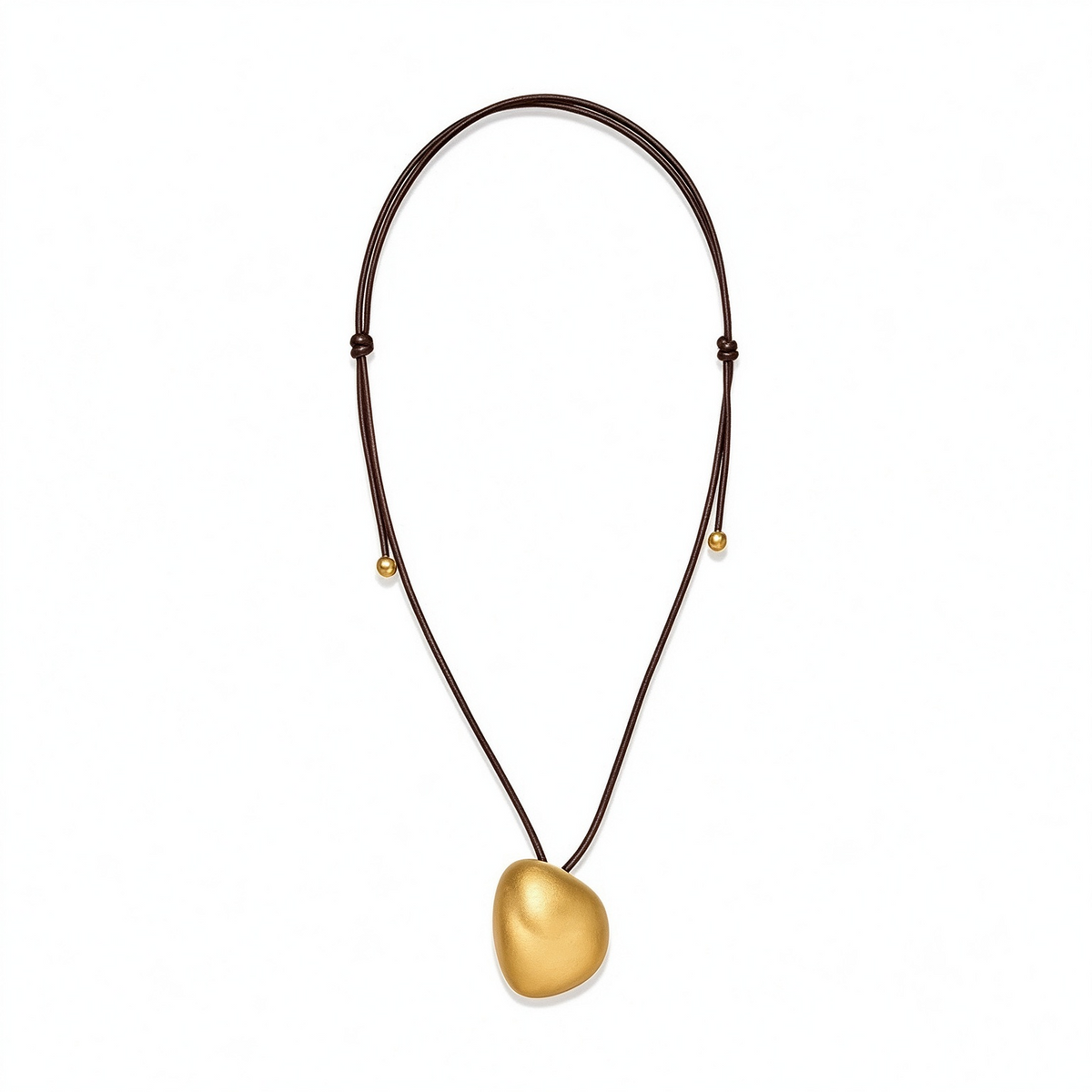 Gold-tone sculptural pebble pendant necklace with an adjustable dark cord on a white background