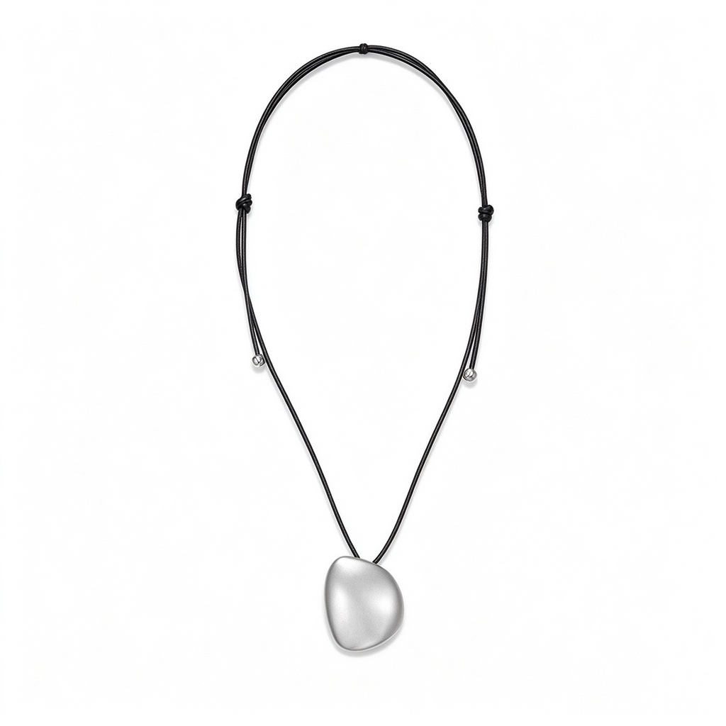 Silver-tone sculptural pebble pendant necklace with an adjustable black cord on a white background