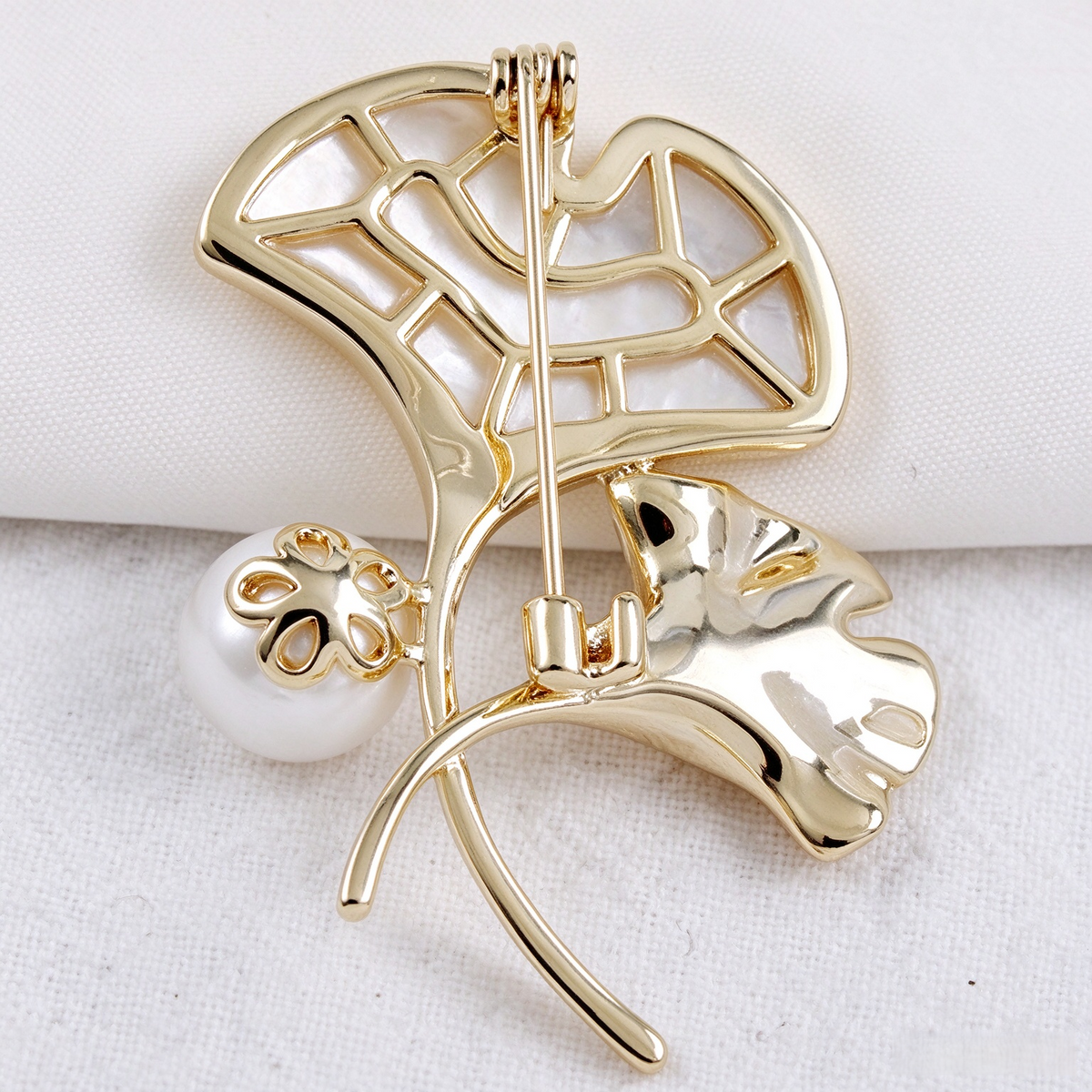 Back view of shell ginkgo brooch with pin fastening