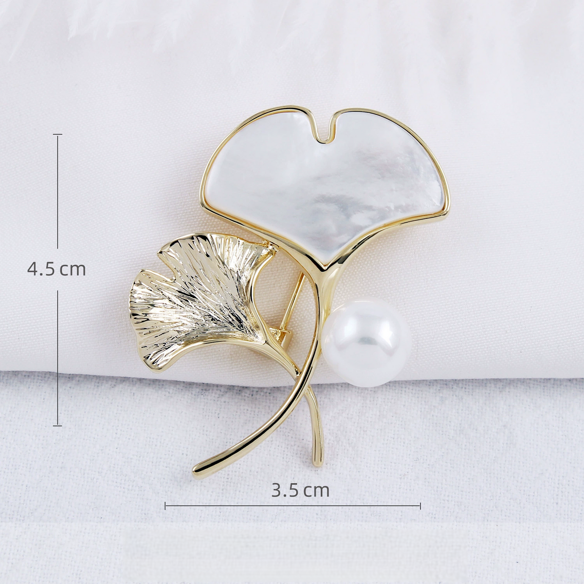 Shell ginkgo brooch measuring approximately 4.5 by 3.5 cm