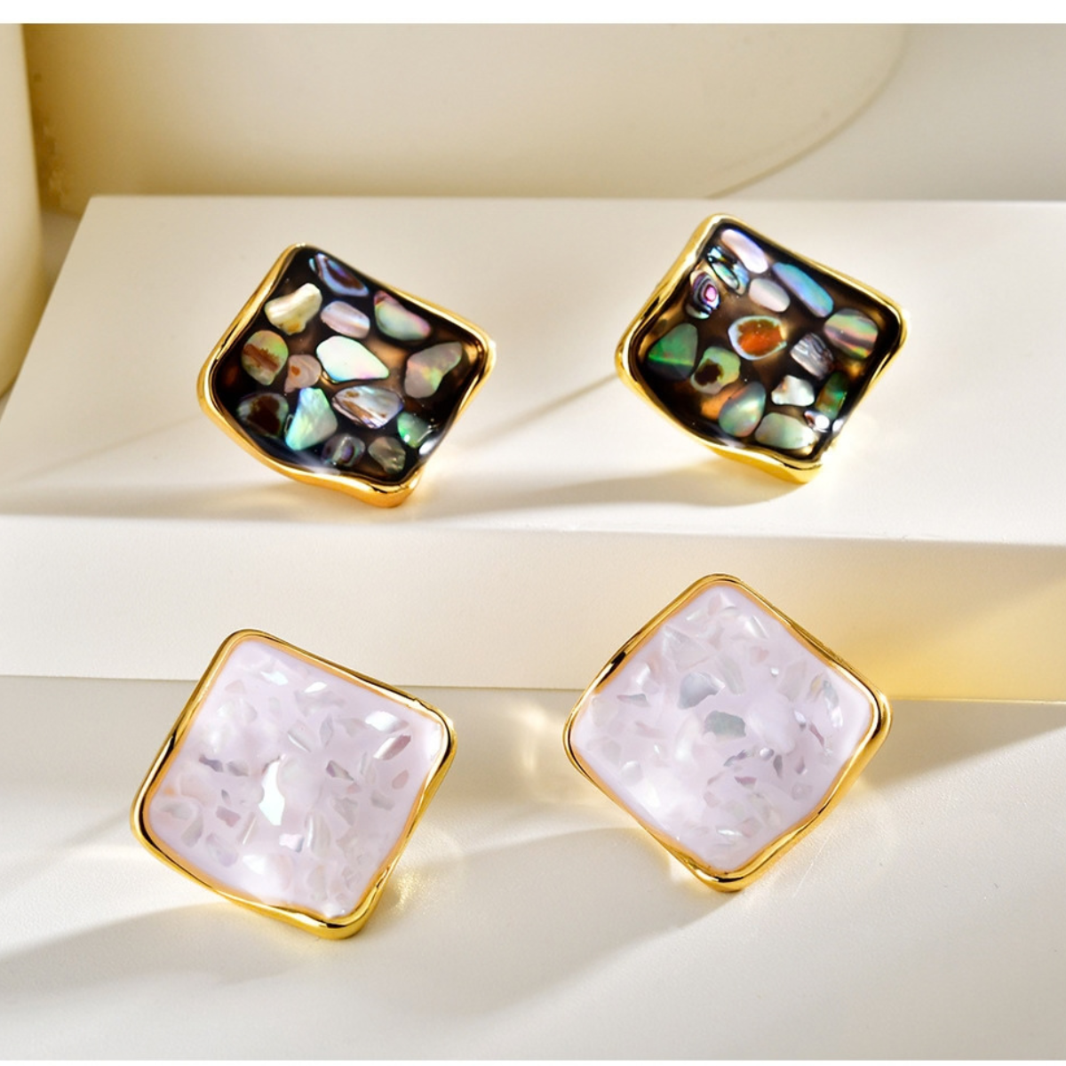 Square shell stud earrings shown in dark abalone and light shell variations