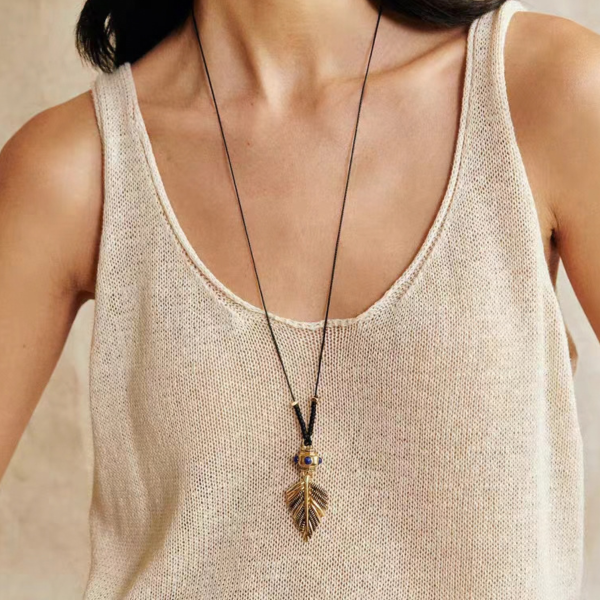 Gold-Tone botanical leaf pendant necklace with natural stone accents