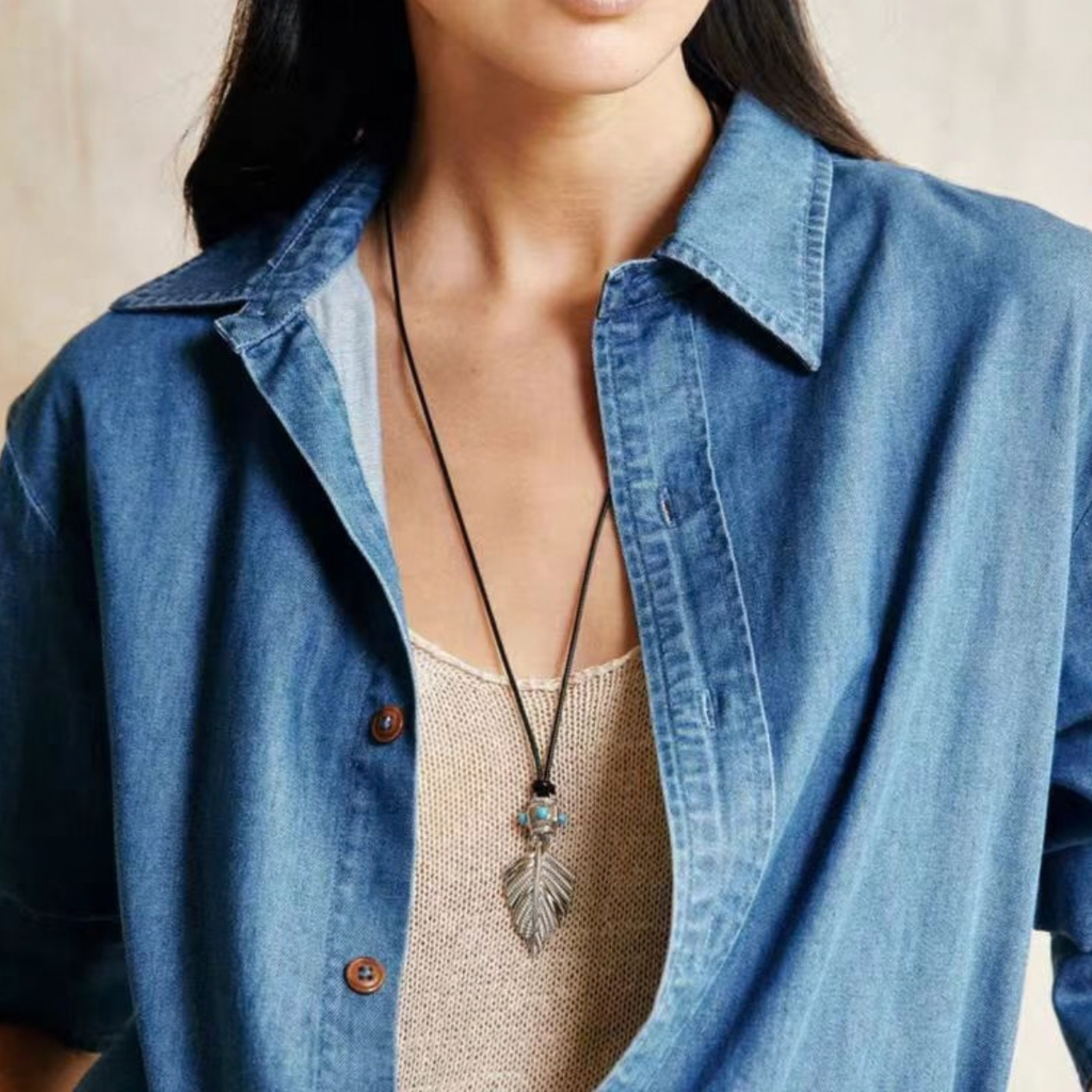 Silver-Tone botanical leaf pendant necklace worn on a black cord