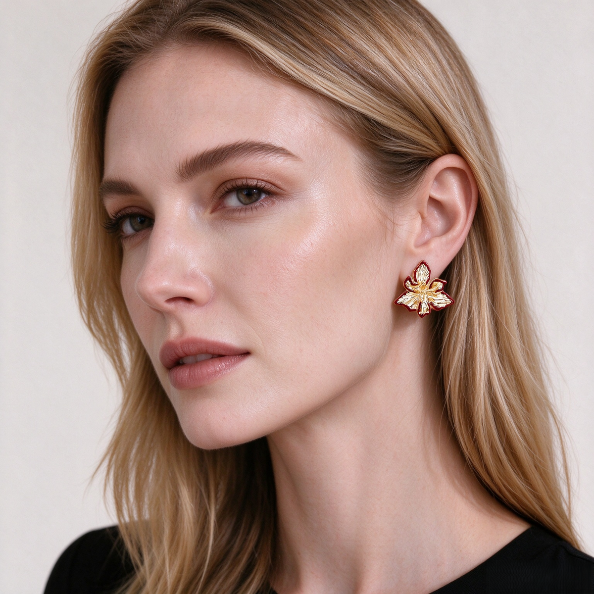 Model wearing gold-tone Textured Iris Flower Stud Earrings