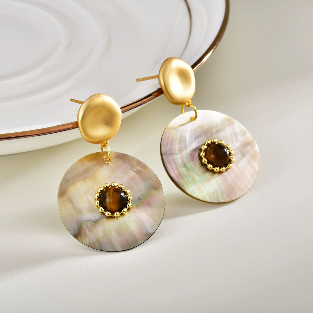 Close-up of Tiger Eye and iridescent Abalone Shell drop earrings
