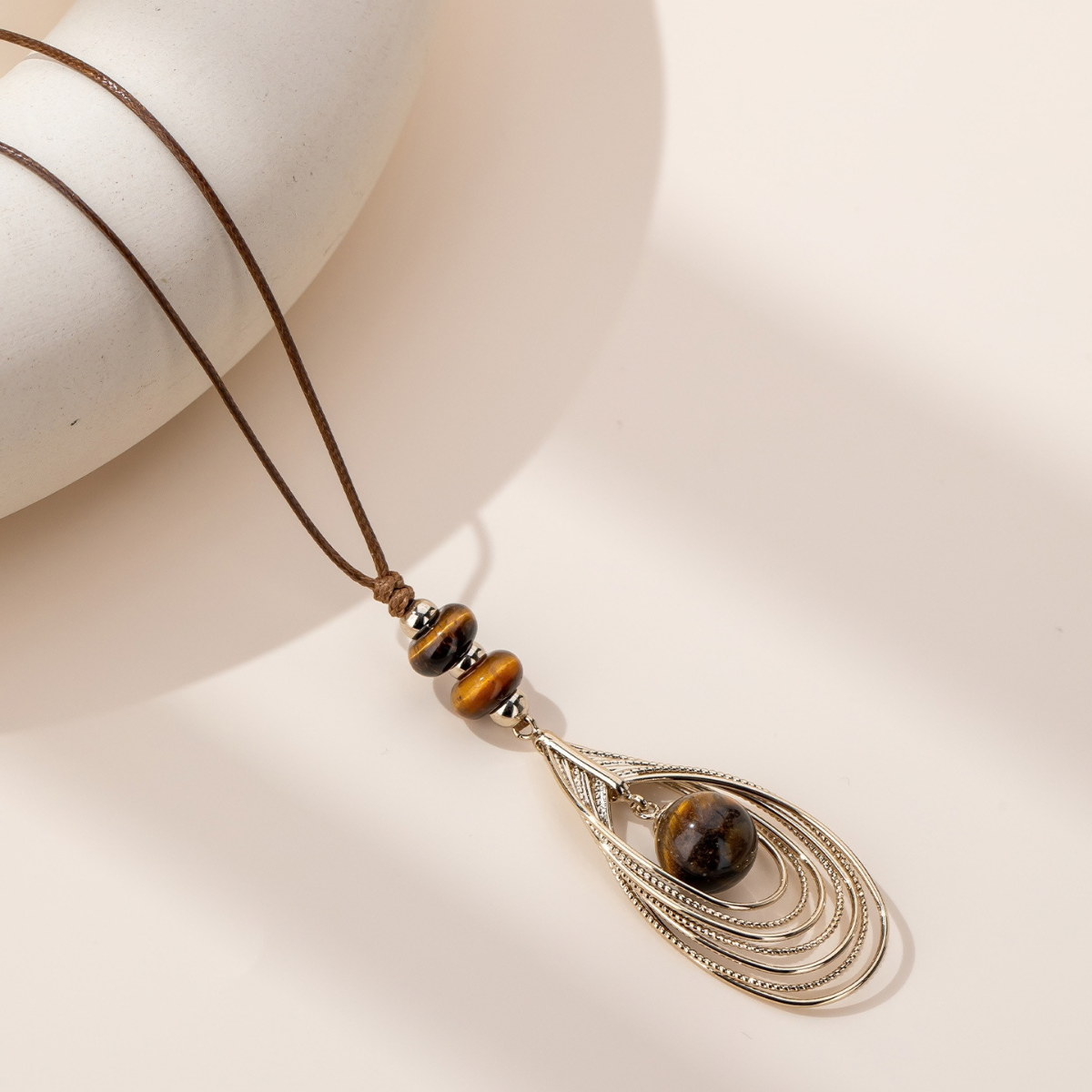 Tiger eye long pendant necklace with layered sculptural metalwork