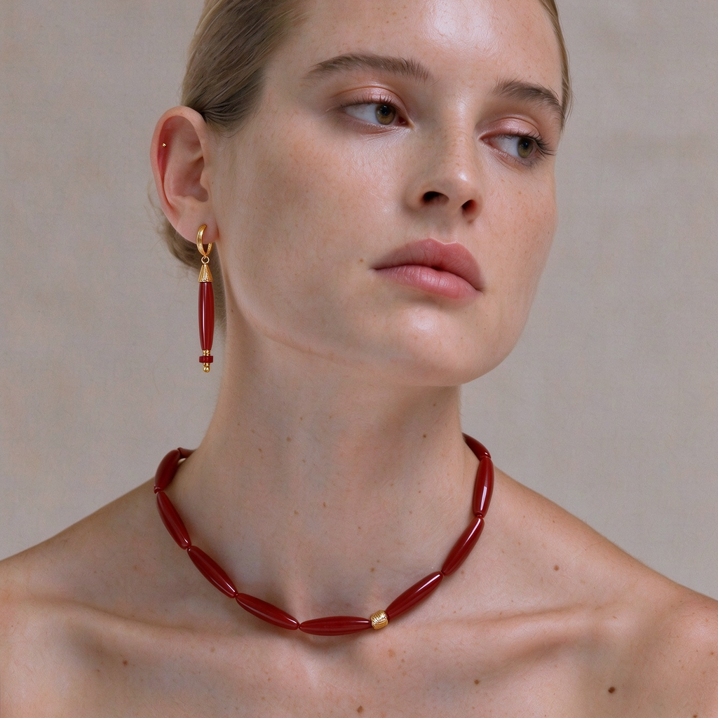 Model wearing the Vessel Red Agate collar necklace with matching drop earrings