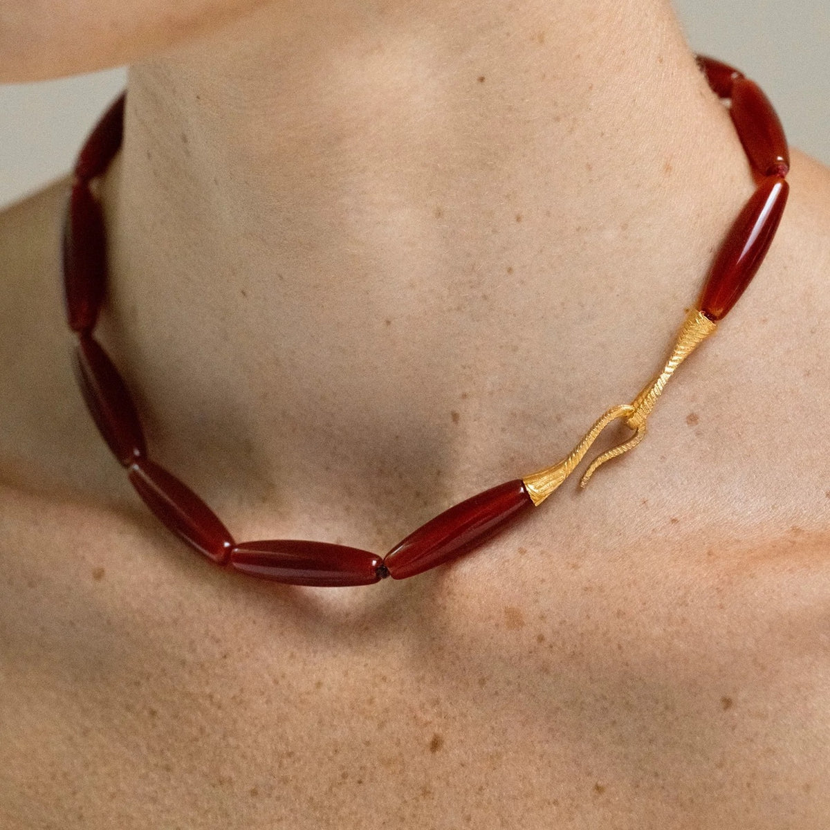 Model wearing the Vessel Red Agate collar necklace details
