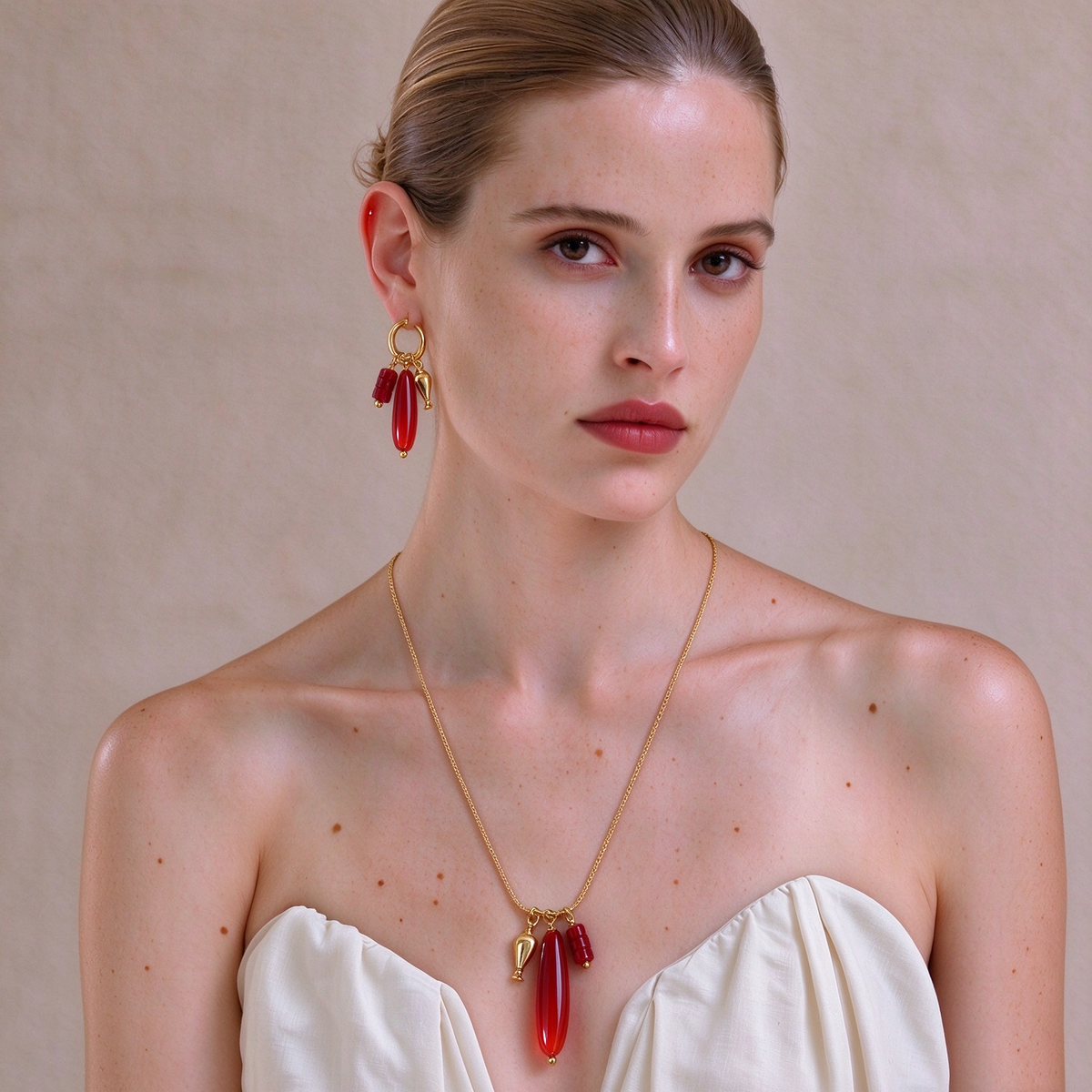 Model wearing the Vessel Red Agate long necklace with matching sculptural earrings
