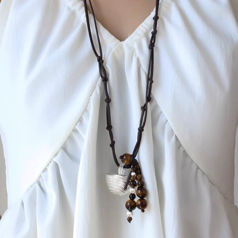 Woven Basket Tiger Eye Pendant Necklace worn long with brown wax cord